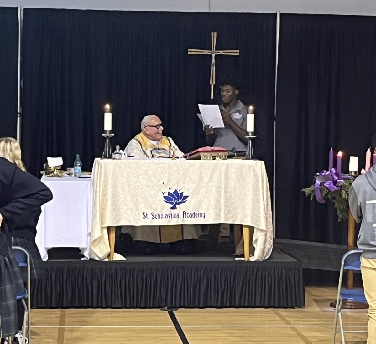 Msgr. Frank shares the joke-telling duties with Catholic High students