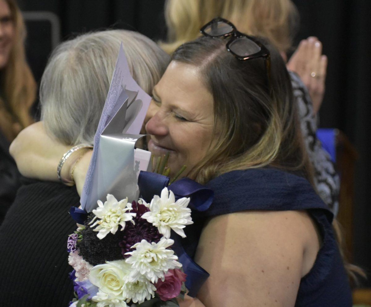 Alum of the Year Marcelle Delaune hugs her former teacher, Patrice Cedor, recipient of the Marguerite Celestin Award